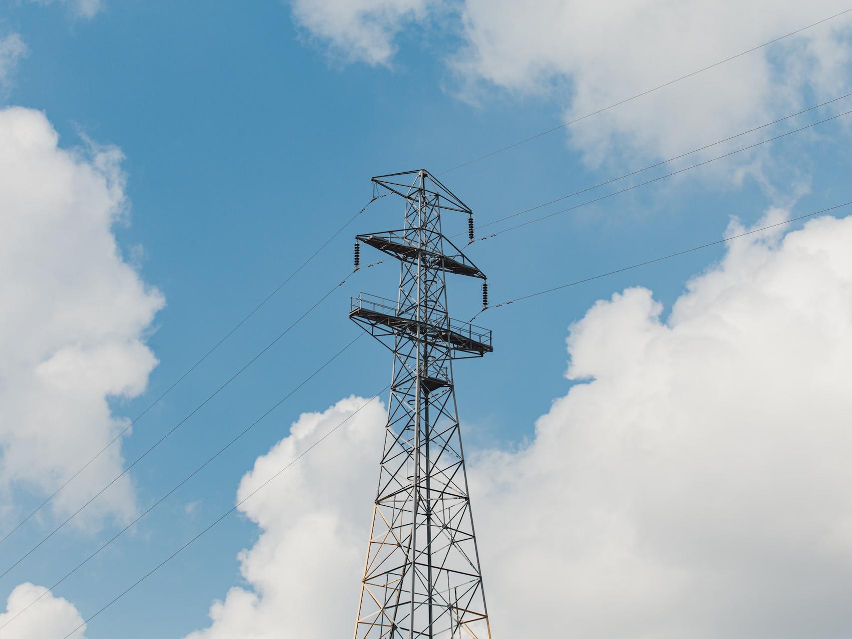 Gallery Image 02 black metal tower under blue sky and white clouds during daytime